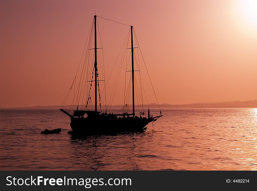 Yacht silhouette and red sunset at Red sea, Egypt