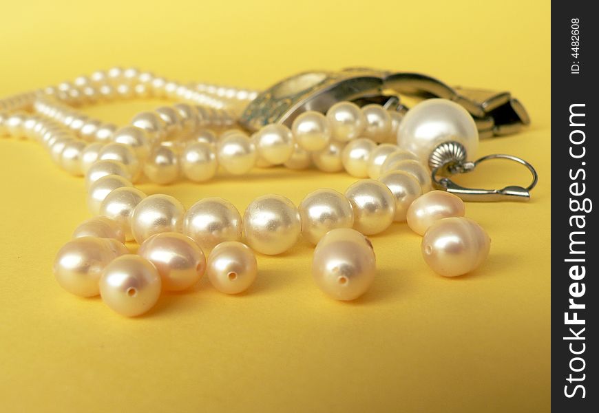 String of pearls on yellow background. String of pearls on yellow background