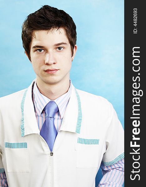 Young handsome caucasian doctor wearing smock