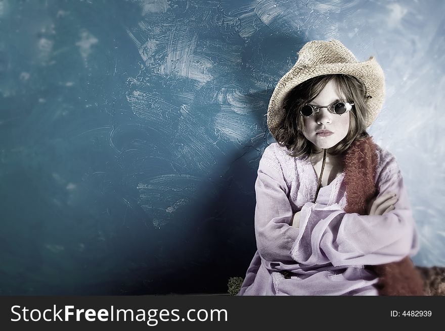 Mad Young Girl Wearing a Straw Cowboy Hat and Funny Sunglasses. Mad Young Girl Wearing a Straw Cowboy Hat and Funny Sunglasses