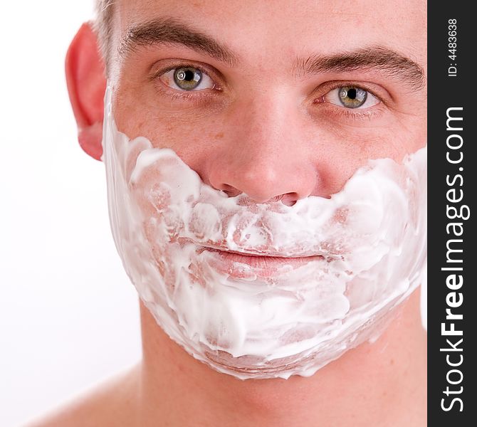 Young man with shaving foam on his face. Young man with shaving foam on his face