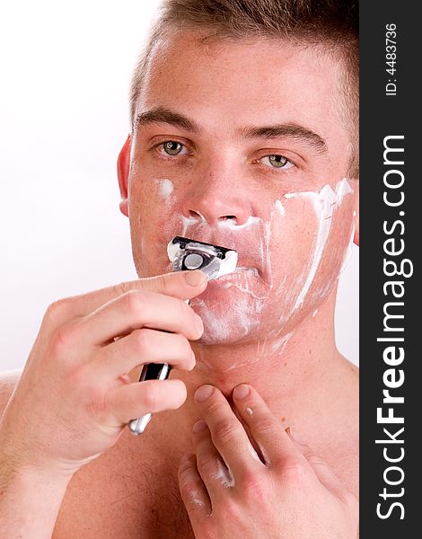 Young man with shaving foam on his face. Young man with shaving foam on his face