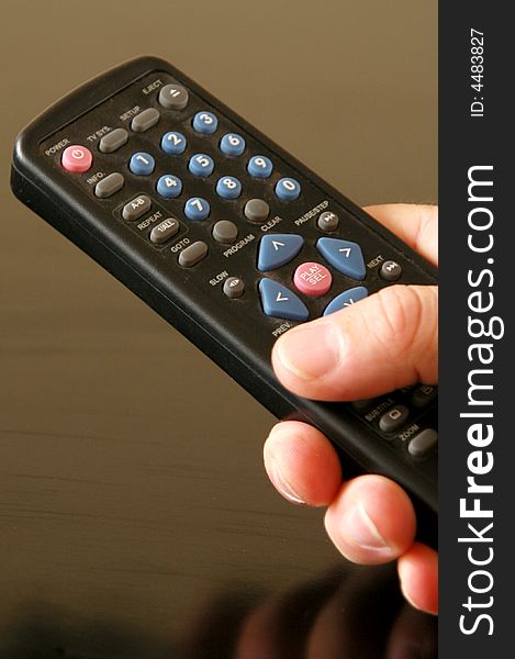 A black remote control being operated