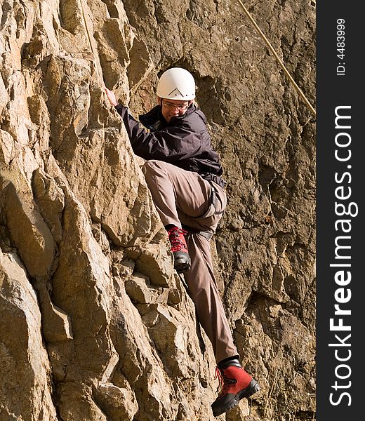 Climber swarming up the rock wall