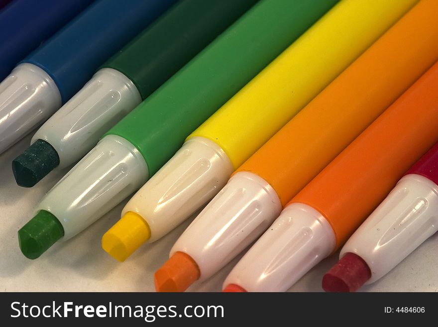 A rainbow gradient of plastic coated crayons. A rainbow gradient of plastic coated crayons