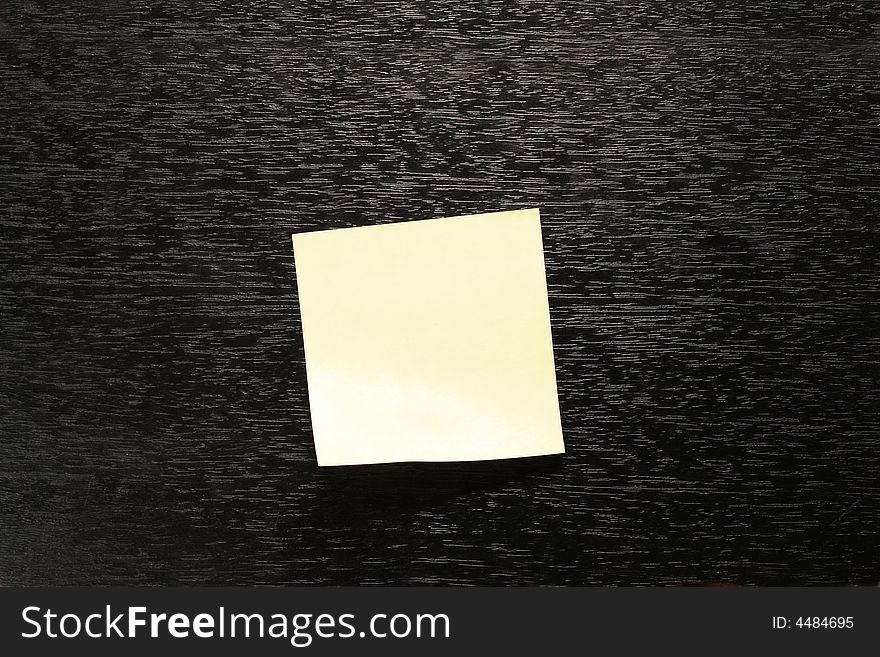 Yellow paper sticker on black background