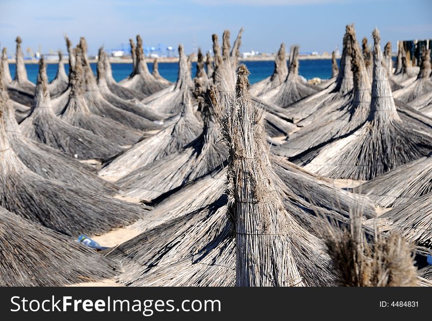 Blue sky with straw roofs at tropical beach area