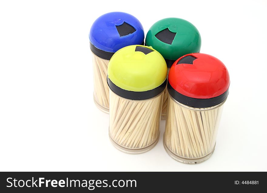 Four toothpick bottles on a white surface