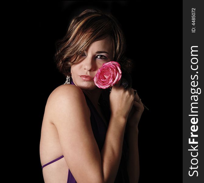 Portrait of young model holding pink rose. Portrait of young model holding pink rose