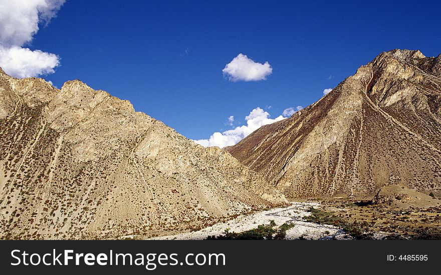 It is mountain and the blue sky. location is in Tibet of China. It is mountain and the blue sky. location is in Tibet of China.