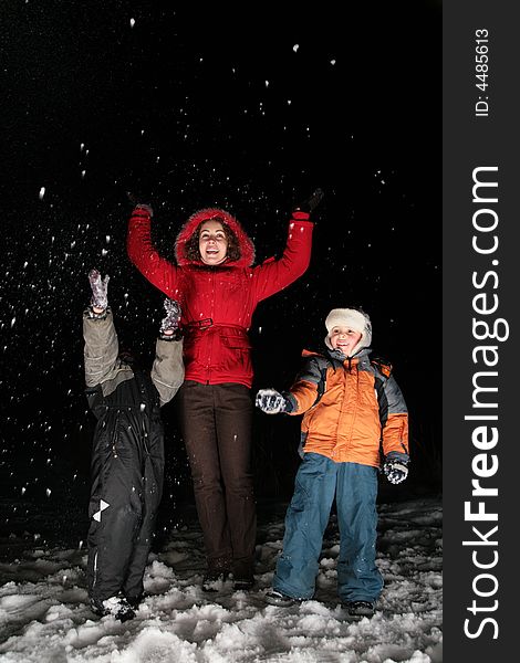 Children and mother throw snow in the night 3