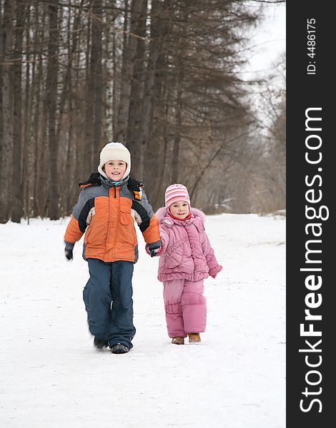 Brother and sister walk in park