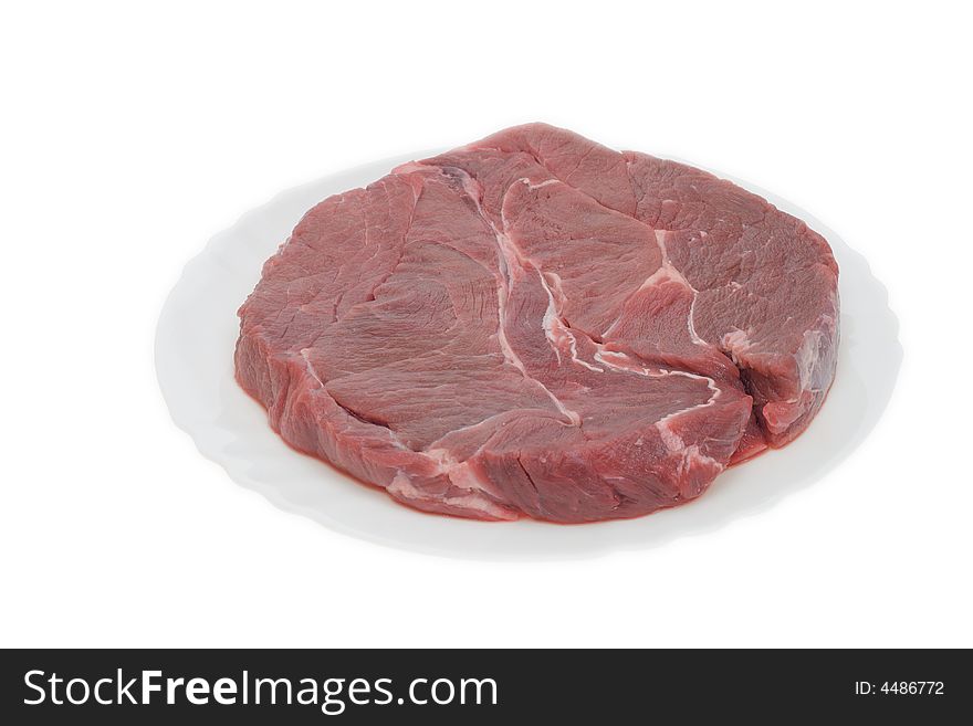 A big piece of meat on the plate isolated on white. A big piece of meat on the plate isolated on white