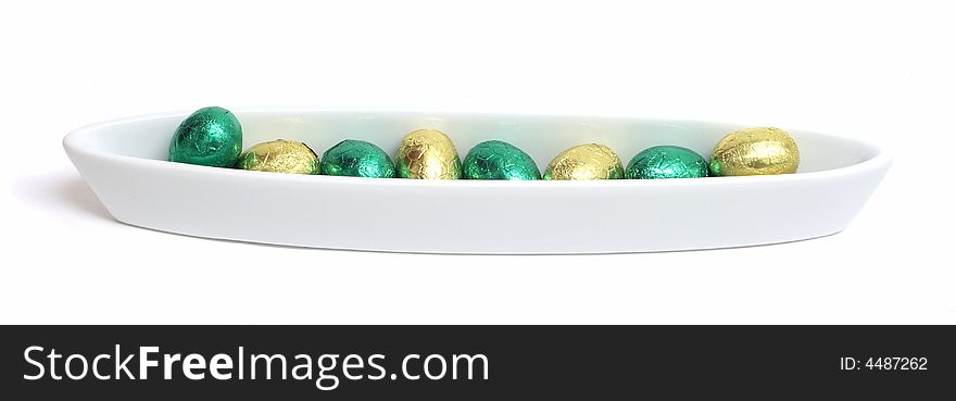 Bowl with green and gold chocolate easter eggs. Bowl with green and gold chocolate easter eggs