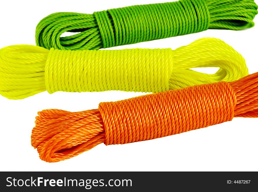Color ropes. Focus on ornge rope. Isolated on white.