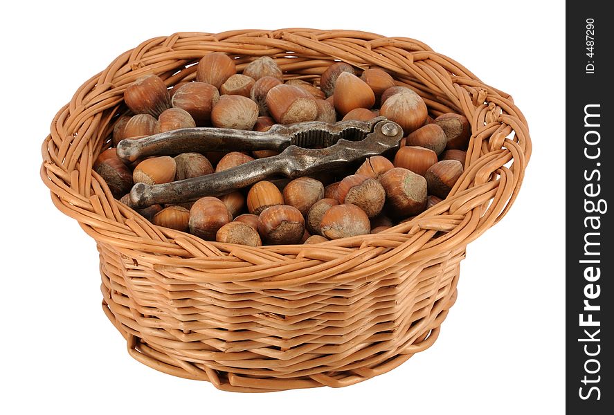 Basket of whole hazelnuts with cracker, isolated on white.