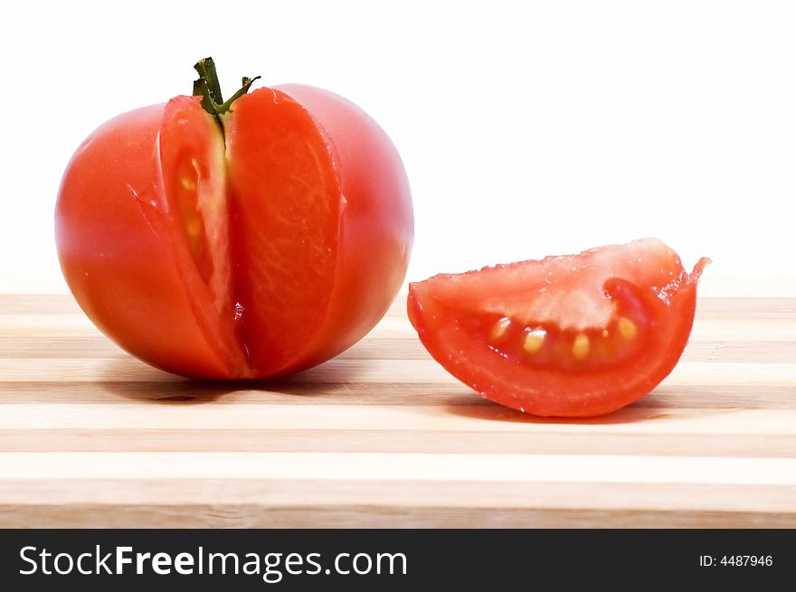 Juicy Tomato On Wooden Plate