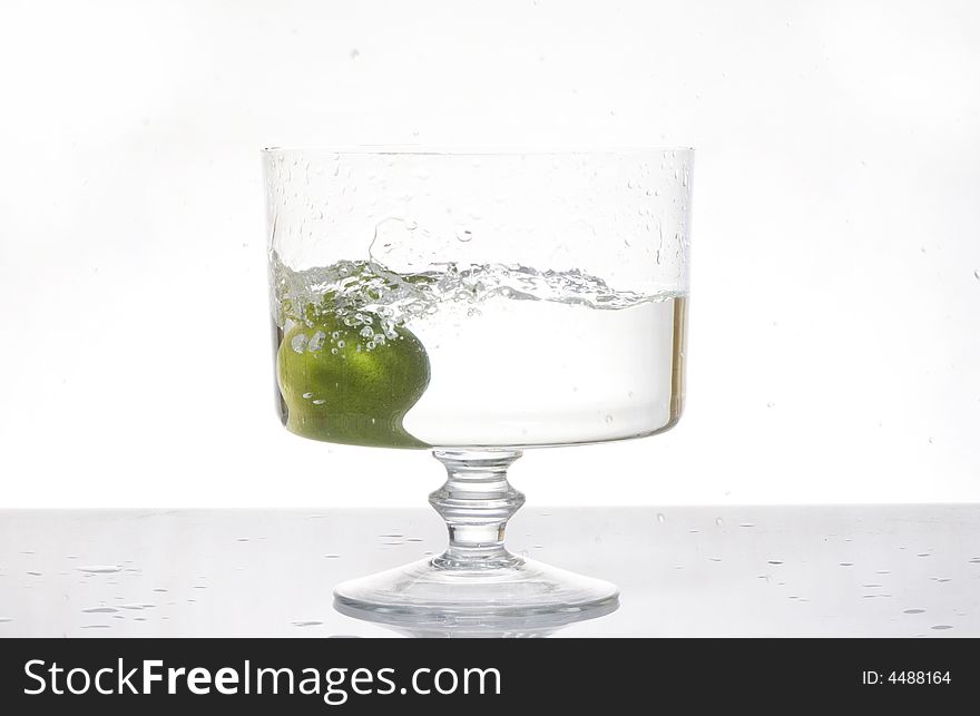 Fresh lemon splash into water on the white background