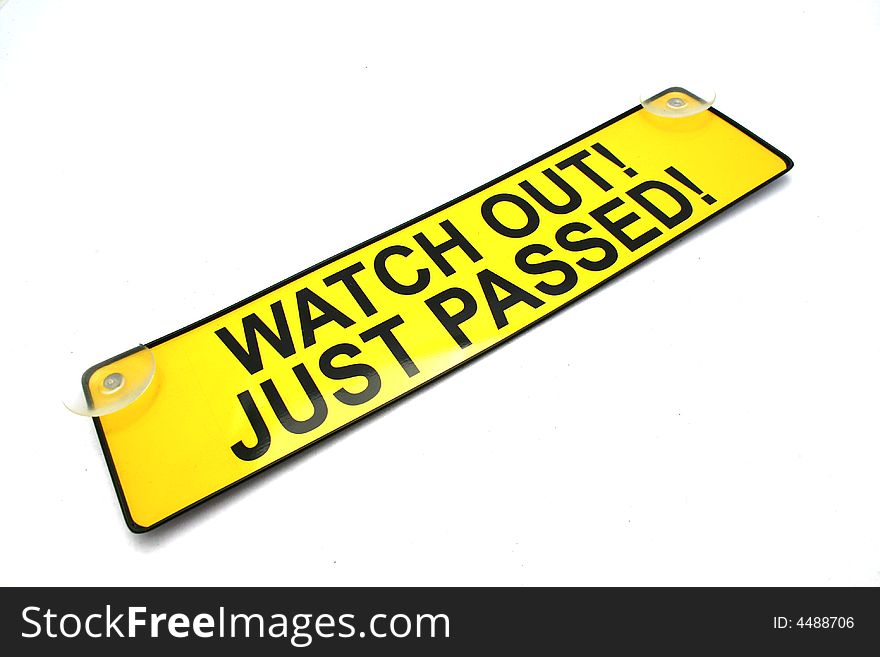 A bright yellow warning sign for use of a new driver. isolated on a white background. A bright yellow warning sign for use of a new driver. isolated on a white background