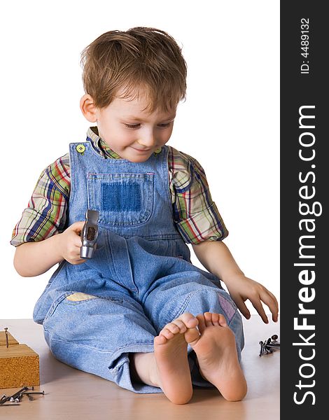 Kid hammers a hammer in nails