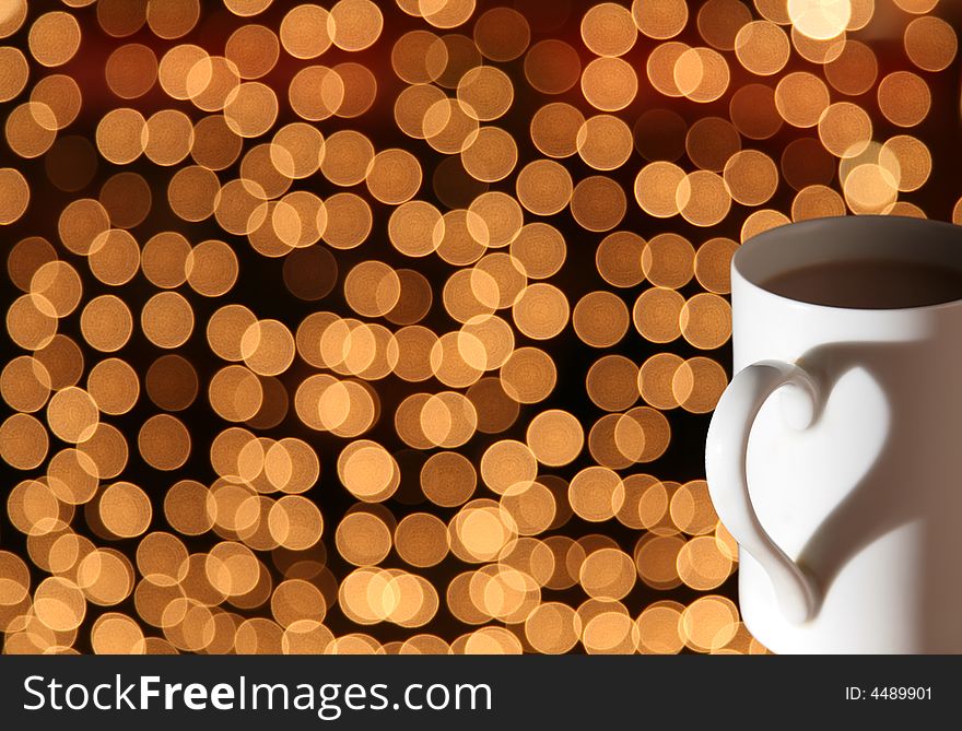 Cup with shadow heart on bokeh lights. Cup with shadow heart on bokeh lights