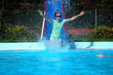 Girl Going Down Slide Into Swimming Pool Royalty Free Stock Photography