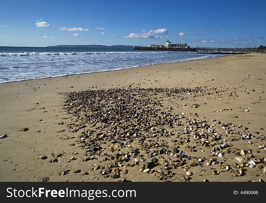 Bournemouth pier from beach with blue sky. Bournemouth pier from beach with blue sky