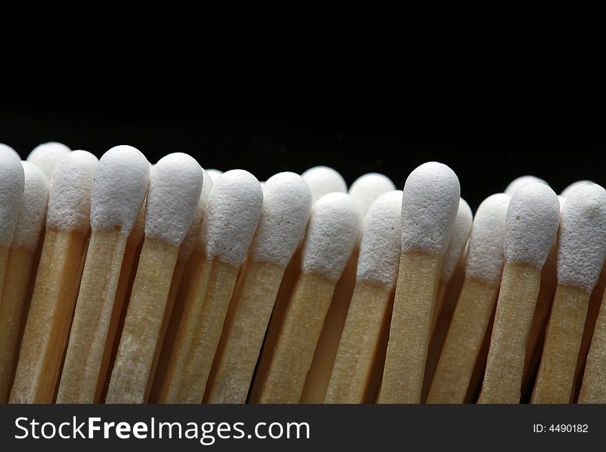 A row of matches isolated on black