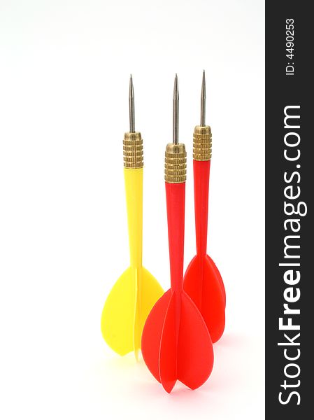 Three darts over a white surface