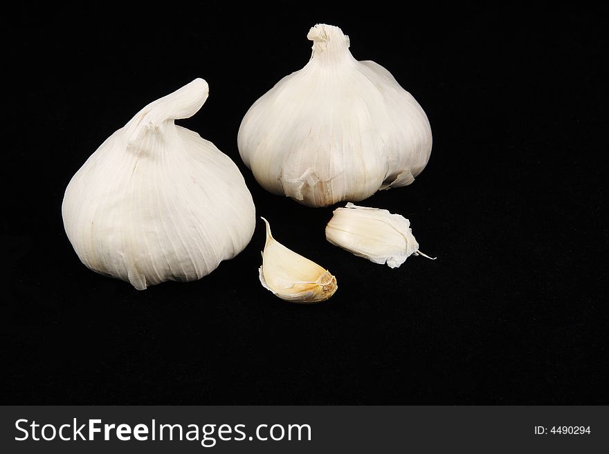 Garlic cloves on a black background. Garlic cloves on a black background