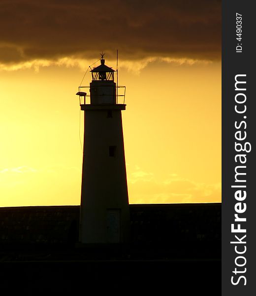 Lighthouse - beautiful yellow-black sunset scene