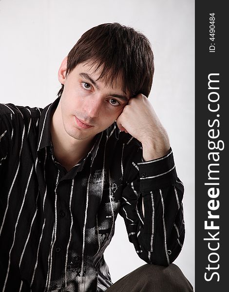 Young man in dark shirt on white background