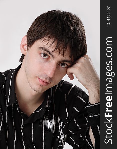 Young man in dark shirt on white background