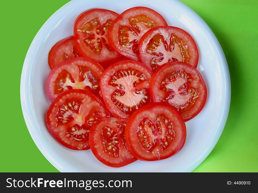 Fresh sliced tomato on a white plate. Fresh sliced tomato on a white plate