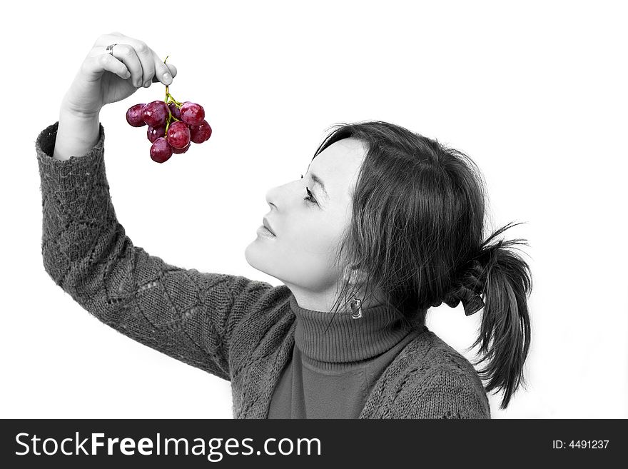 Young girl is holding grapes in the palm