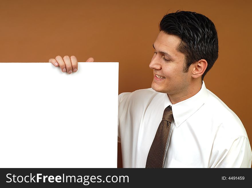 Cheerful businessman holding poster copy space; easily extendable for banner size. Cheerful businessman holding poster copy space; easily extendable for banner size