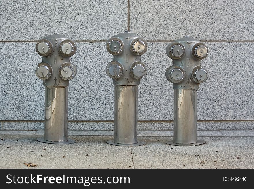 Architectural detail shot of ornamental fire department connections for a modern skyscraper office building.