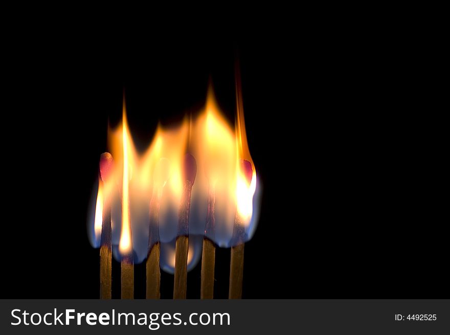 Six matches burning isolated on black. Six matches burning isolated on black
