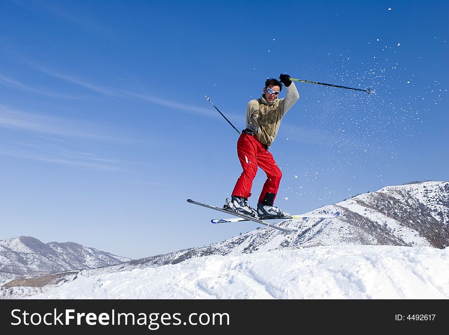 Snow Skier Jumping Over Blue Sky