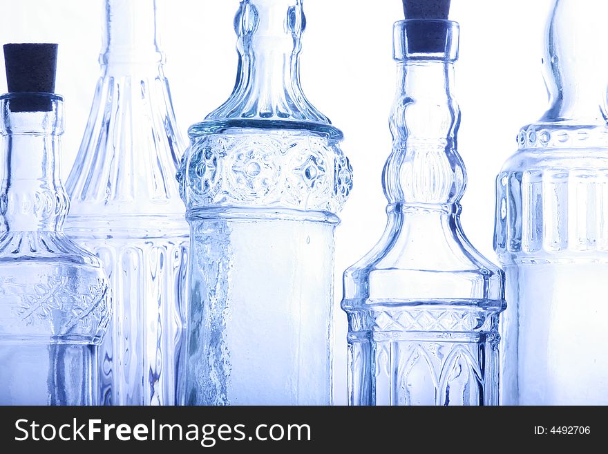 Bottles illuminated against a white backdrop.