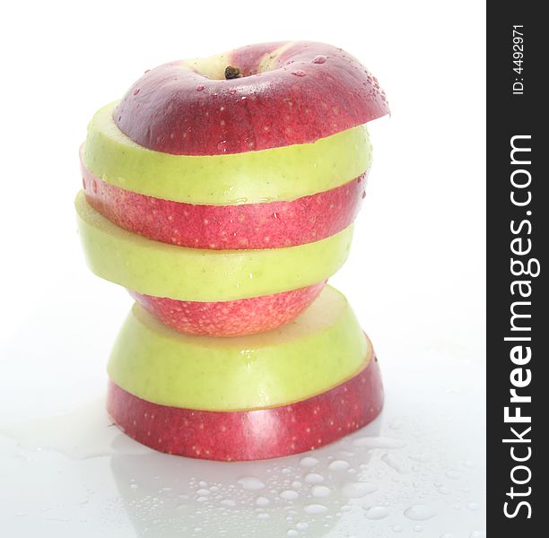 Wet striped apple on a white background