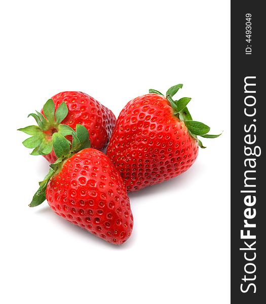 Close up of three fresh strawberries isolated over white