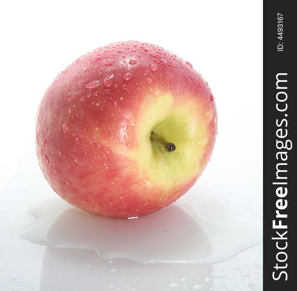 Wet red apple on a white background