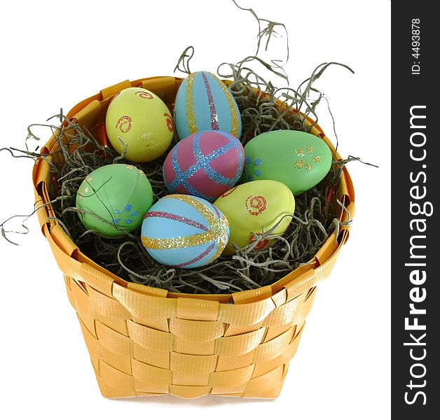 Several decorated Easter eggs in a yellow basket. Several decorated Easter eggs in a yellow basket.