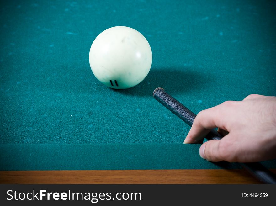 The young guy plays billiards. The young guy plays billiards