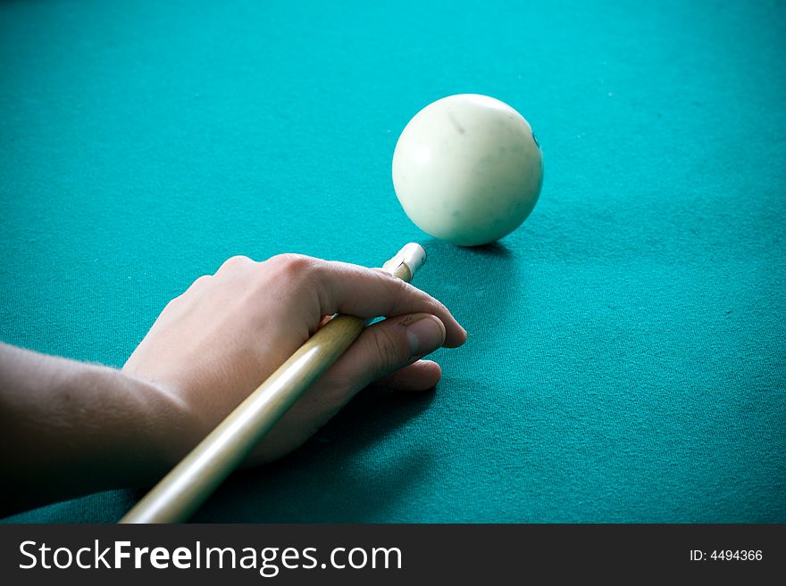 The young guy plays billiards. The young guy plays billiards