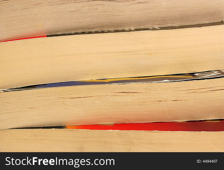 Four stacked paperback books background