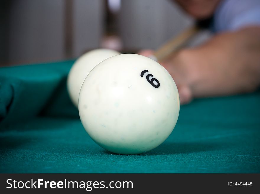 The young guy plays billiards. The young guy plays billiards