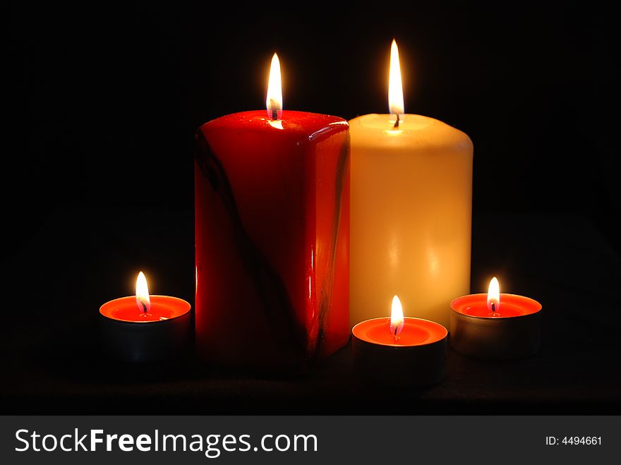 Five candles on a black background