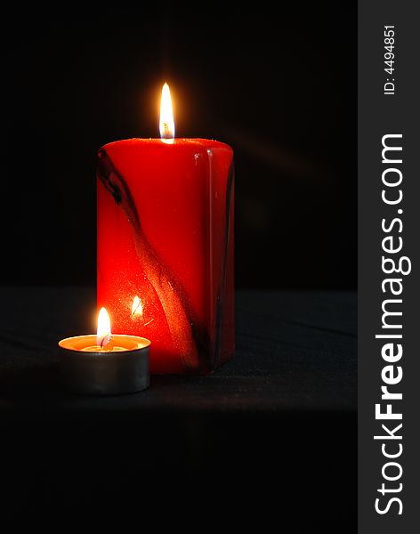 Two candles on a black background